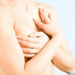 Woman's chest, hands gently touching